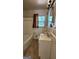Bathroom featuring a vanity, toilet, and bathtub with a window providing natural light at 766 Virginia Cir, Forest Park, GA 30297