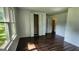 Bright bedroom with wood floors, large window, closet, and access to another room at 766 Virginia Cir, Forest Park, GA 30297