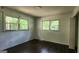 Bedroom featuring wood floors, two windows, and a closet; natural light at 766 Virginia Cir, Forest Park, GA 30297