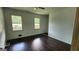 Bedroom with wood floors and large windows overlooking the front of the property at 766 Virginia Cir, Forest Park, GA 30297