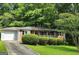 A charming brick home with a one-car garage and a well-maintained front yard at 766 Virginia Cir, Forest Park, GA 30297