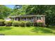Charming brick home with a well-manicured lawn and mature trees offers great curb appeal at 766 Virginia Cir, Forest Park, GA 30297