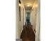 Inviting hallway with rich, dark wood flooring and neutral wall tones, leading to other rooms in the home at 766 Virginia Cir, Forest Park, GA 30297