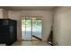 View of a kitchen with a sliding glass door, black refrigerator, and access to a deck at 766 Virginia Cir, Forest Park, GA 30297