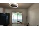 View of the kitchen featuring sliding glass doors leading to a deck and black refrigerator at 766 Virginia Cir, Forest Park, GA 30297