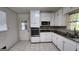 Kitchen featuring white cabinets and updated stainless steel appliances and countertops at 766 Virginia Cir, Forest Park, GA 30297