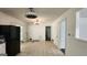 Bright eat-in kitchen featuring tile floors, white cabinets, black refrigerator, and modern ceiling fans at 766 Virginia Cir, Forest Park, GA 30297
