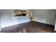 Open-concept living room with dark hardwood floors and view to the kitchen at 766 Virginia Cir, Forest Park, GA 30297