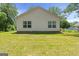 Backyard with a well-maintained lawn and white siding at 23 Skyland W Dr, Locust Grove, GA 30248