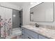Bathroom featuring modern fixtures, gray tile, and a floral shower curtain at 23 Skyland W Dr, Locust Grove, GA 30248