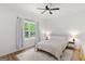 Bedroom showcasing a large window, ceiling fan, and natural light at 23 Skyland W Dr, Locust Grove, GA 30248