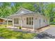 Side view of this home showing the porch and dark driveway at 23 Skyland W Dr, Locust Grove, GA 30248