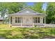 Charming single-story home featuring a welcoming front porch and well-manicured lawn at 23 Skyland W Dr, Locust Grove, GA 30248