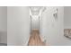 Hallway featuring wood look floors and white doors at 23 Skyland W Dr, Locust Grove, GA 30248