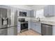 Kitchen boasts stainless steel appliances and light gray cabinets at 23 Skyland W Dr, Locust Grove, GA 30248