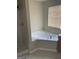 Bathroom featuring a corner tub, separate shower, and window with blinds at 8170 Oakley Cir # 2, Union City, GA 30291
