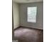 Bedroom featuring brown carpet and a window with blinds at 8170 Oakley Cir # 2, Union City, GA 30291