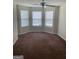 Bedroom with brown carpet, ceiling fan, and bay window allowing natural light at 8170 Oakley Cir # 2, Union City, GA 30291