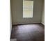 Bedroom with brown carpet, one window with blinds, and neutral wall color at 8170 Oakley Cir # 2, Union City, GA 30291