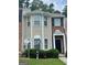 Two-story townhome with brick and vinyl siding, tidy landscaping, and inviting front porch at 8170 Oakley Cir # 2, Union City, GA 30291
