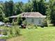 Exterior of a property with a ladder, belongings, and an overgrown yard at 72 N Pomona N Rd, Hampton, GA 30228