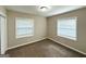Clean bedroom with carpet flooring, neutral paint, and natural light from two windows with white blinds at 3115 Pinehill Dr, Decatur, GA 30032