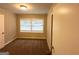 Simple bedroom with carpet flooring, neutral paint, one window with blinds, and a view into the hallway at 3115 Pinehill Dr, Decatur, GA 30032
