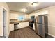 Modern kitchen featuring stainless steel appliances, granite countertops, and white cabinets with dark floors at 3115 Pinehill Dr, Decatur, GA 30032