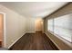 Open living area with hardwood floors, neutral paint, white trim, and a view of an adjacent room at 3115 Pinehill Dr, Decatur, GA 30032