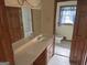 Bathroom featuring a double vanity with lots of space, wood cabinetry, and tile floors at 5125 Flakes Mill Rd, Ellenwood, GA 30294
