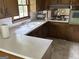 Traditional kitchen featuring wood cabinets, a double basin sink, and a view to the living room at 5125 Flakes Mill Rd, Ellenwood, GA 30294