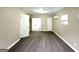 Large bedroom with large closet, neutral walls, large window and carpeted floor at 1362 Mill Lake Cir, Stone Mountain, GA 30088