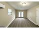 Spacious bedroom with large window, French doors, neutral walls and carpeted floor at 1362 Mill Lake Cir, Stone Mountain, GA 30088