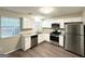 Bright kitchen features stainless steel appliances, white cabinets, and granite countertops at 1362 Mill Lake Cir, Stone Mountain, GA 30088