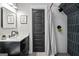 Modern bathroom featuring a sleek vanity, stylish mirror, and walk-in shower with decorative tile accent wall at 2490 S Carroll St, Villa Rica, GA 30180
