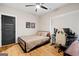 Bedroom with modern decor, neutral walls, light-colored hardwood floors, and gaming setup at 2490 S Carroll St, Villa Rica, GA 30180