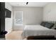 Bedroom with a modern design, neutral-colored walls, light-colored hardwood floors, and simple decor at 2490 S Carroll St, Villa Rica, GA 30180