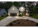 Charming two-story modern farmhouse with a gray garage, concrete driveway, and lush landscaping at 2490 S Carroll St, Villa Rica, GA 30180
