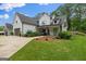 Beautiful two-story modern farmhouse with a gray garage, concrete driveway, and lush landscaping at 2490 S Carroll St, Villa Rica, GA 30180