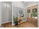 Charming foyer with wood floors, a console table, decorative mirror, and double doors with wreath accents at 2490 S Carroll St, Villa Rica, GA 30180