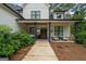 Inviting front porch with seating, wood ceiling, and decorative columns creating a welcoming outdoor space at 2490 S Carroll St, Villa Rica, GA 30180