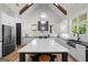 Spacious kitchen with a large island, white cabinetry, stainless steel appliances, and modern pendant lighting at 2490 S Carroll St, Villa Rica, GA 30180