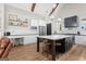 Modern kitchen boasts white cabinetry, stainless steel appliances, a central island with seating, and stylish pendant lighting at 2490 S Carroll St, Villa Rica, GA 30180