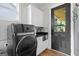 Bright laundry room featuring stainless steel sink, modern washer, gray subway tile backsplash, and access to the outside at 2490 S Carroll St, Villa Rica, GA 30180