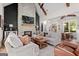 Beautiful living room with a striking stone fireplace, beamed ceilings, and an open layout to the dining area at 2490 S Carroll St, Villa Rica, GA 30180