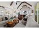 Bright and open living area featuring vaulted ceilings with wooden beams, seamlessly connecting to the kitchen and dining space at 2490 S Carroll St, Villa Rica, GA 30180