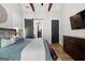 Main bedroom with wood-beamed ceilings, chandelier, television, and dark-stained hardwood flooring at 2490 S Carroll St, Villa Rica, GA 30180