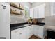 Charming mud room with white cabinetry, black countertops, floating shelves, and a view of the outside at 2490 S Carroll St, Villa Rica, GA 30180