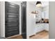 Convenient mud room featuring a sliding barn door, white cabinets, and stylish countertops for organization and functionality at 2490 S Carroll St, Villa Rica, GA 30180