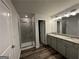 Bathroom with dual sink vanity and glass shower at 142 Tye St, Stockbridge, GA 30281